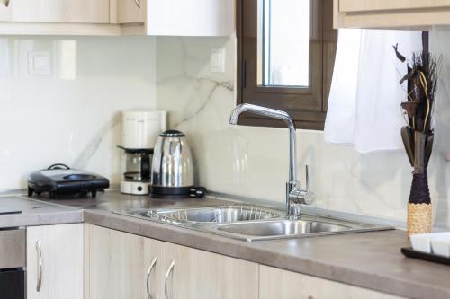 a kitchen with a sink and a counter top at Elena's Apartment in Panormos Rethymno