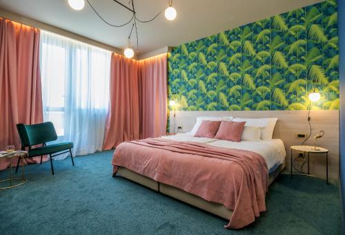 a bedroom with a large bed with a green wall at Priska Med Luxury Rooms in Split