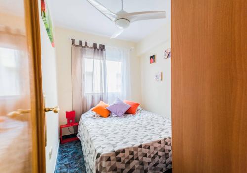 a bedroom with a bed with pillows and a window at Very best flat ust 800m Postiguet-Beach in Alicante