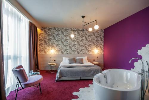 a bedroom with a bed and a bathtub and a bed and a tub at Priska Med Luxury Rooms in Split