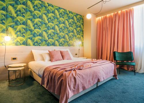 a bedroom with a large bed with a large painting on the wall at Priska Med Luxury Rooms in Split