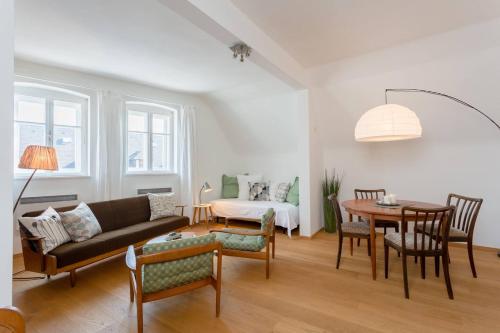 a living room with a couch and a table at Gästesuiten beim Schloss in Eisenstadt