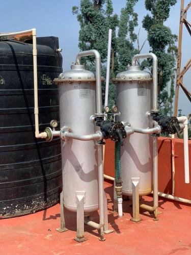 a couple of tanks sitting next to some barrels at Hotel Jc Grand in Kodaikānāl