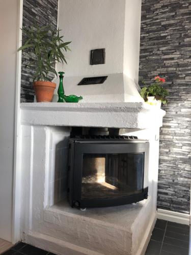 a fireplace with a white mantel with a fire place at Villa utanför Örnsköldsvik, Höga Kusten in Örnsköldsvik