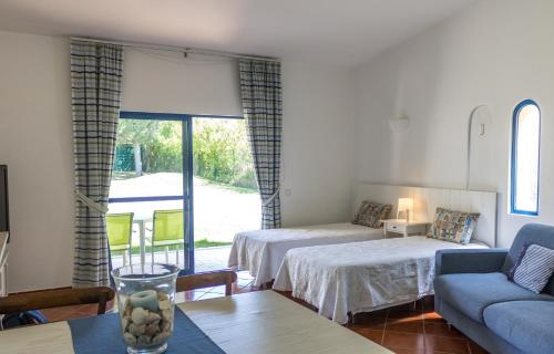 a living room with two beds and a couch at Apartamentos Clube da Bemposta in Alvor