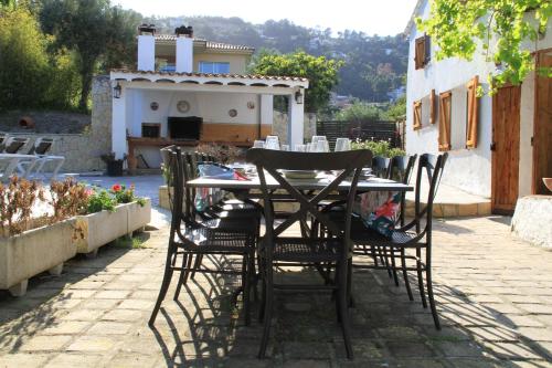 a table and chairs sitting on a patio at Masia Can Magan Lux, Ideal Grupos 20pax in Palafolls