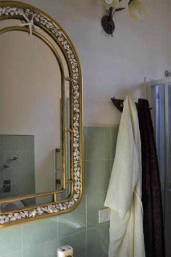 a bathroom with a large mirror on the wall at B&B Le Macine 1868 in Paceco