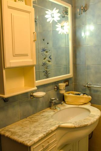 a bathroom with a sink and a mirror at Il Villino in Lucca