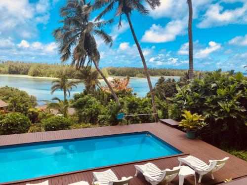 a pool on the deck of a villa with palm trees at Muri Vista Villas in Rarotonga