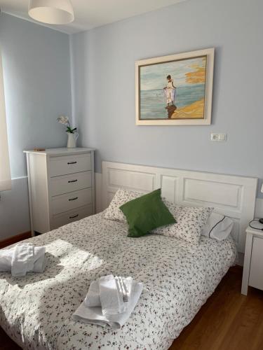 a bedroom with a bed and a painting on the wall at La Casina del Cerecedo in León