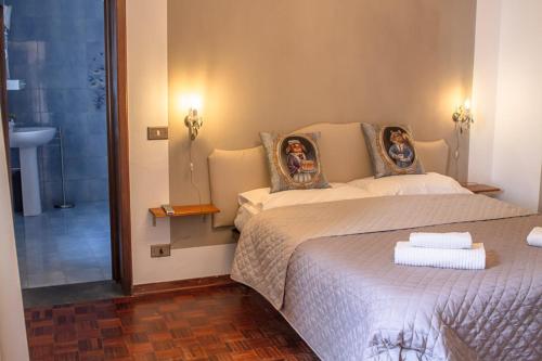a bedroom with a bed with two pictures on the pillows at Il Villino in Lucca