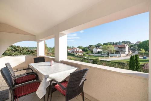 a patio with a table and chairs on a balcony at Apartments Norma in Funtana