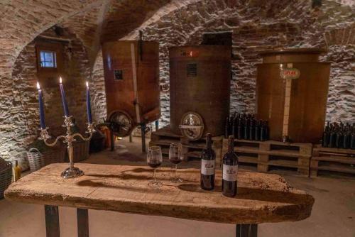 a table with two bottles and two glasses of wine at Tenuta Armonia in Clavesana