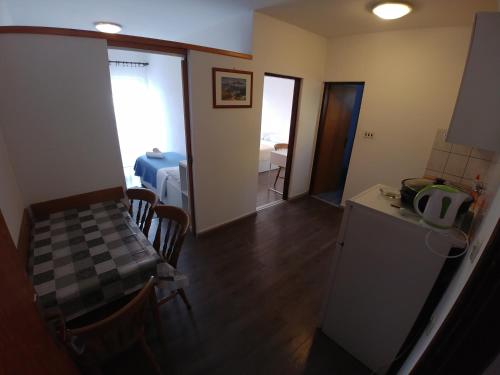 a kitchen and dining room with a table and a refrigerator at Apartmani Sali Seaview in Sali