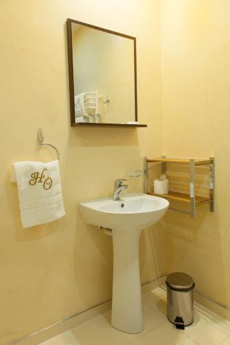 a bathroom with a white sink and a mirror at Hotel Ostrawa in Wodzisław Śląski
