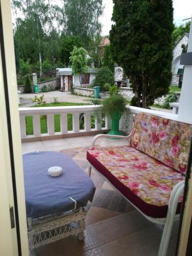 a couch and a table on a patio at Vila Kraljica in Vrdnik