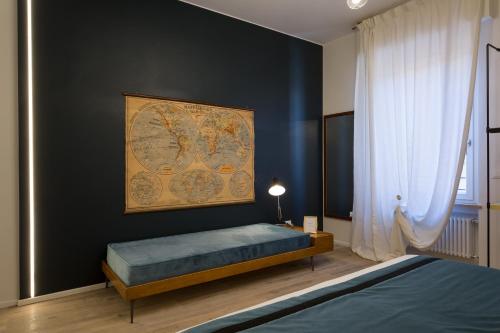 a bedroom with a bed and a map on the wall at Relais Pensiero in Verona