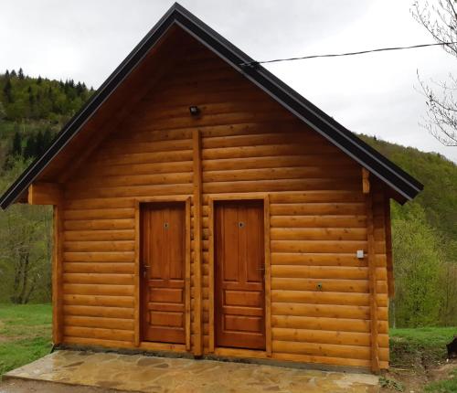 a log cabin with two doors at Gradine - Katun kamp in Plav