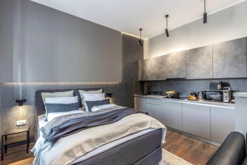 a bedroom with a bed and a kitchen at Deluxe Ploech in Rijeka