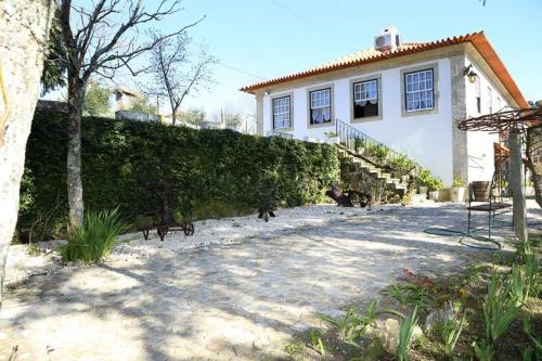 a group of dogs walking in front of a house at Quinta de Vila Verde- Paixão Ancestral, Turismo Rural in Marco de Canaveses