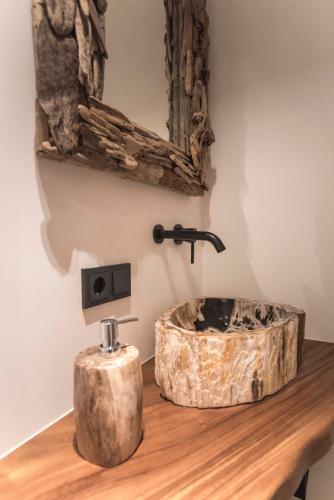 a bathroom with a wooden sink on a wooden table at Sack-Time fashion boutique hotel in Zandvoort