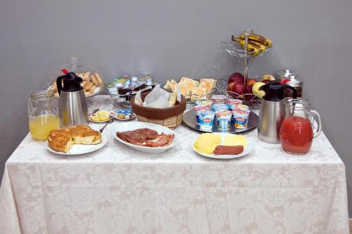 a table with breakfast foods and drinks on it at Operà in Palermo