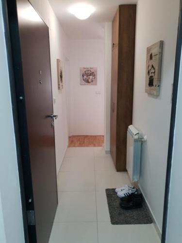 a hallway with a door leading into a room at Tvoj Apartman in Bijeljina