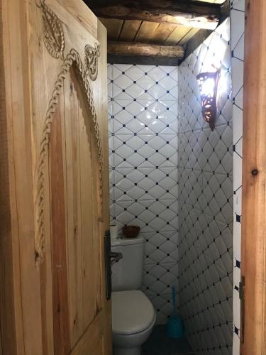 a bathroom with a toilet and a door at Amlougui House in Marrakech