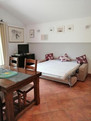 a living room with a bed and a table at Apartment Džoni in Split