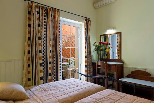 a bedroom with a bed and a window at Marble House in Athens