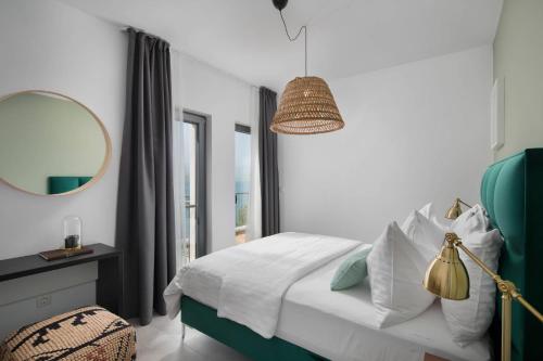 a bedroom with a bed with a mirror and a table at Olive Hill House - ground floor in Slatine