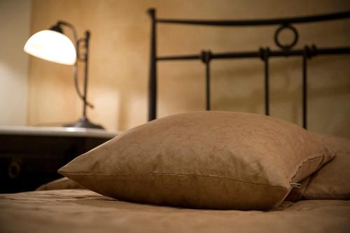 a pillow sitting on a bed next to a lamp at Marble House in Athens