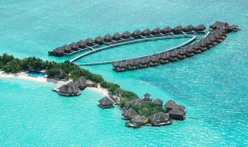 an island with many resorts in the water at Taj Exotica Resort & Spa in South Male Atoll