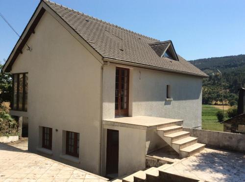 a small white house with stairs in front of it at duplex house un center village in Campeã