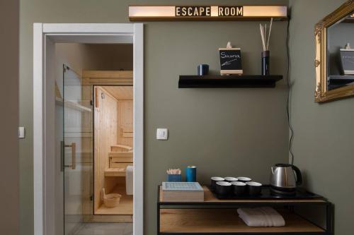 a door to a bathroom with a sink and a mirror at Olive Hill House - ground floor in Slatine