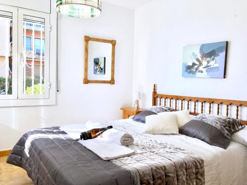 a bedroom with a large bed with white walls at Apartament amb jardi a la platja d'Empuriabrava in Empuriabrava