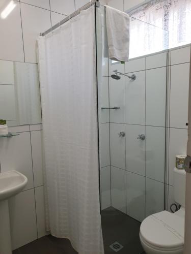 a bathroom with a shower and a toilet at Best Western Endeavour Motel in Maitland