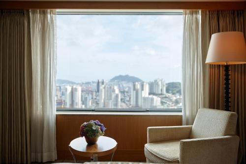 
a living room filled with furniture and a window at Lotte Hotel Busan in Busan
