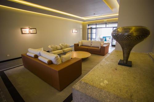 a living room with a couch and a table at Hotel Brazão in Vila do Conde