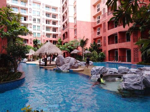 a pool at a resort with people in the water at Seven Seas Condo G619/E519 in Jomtien Beach