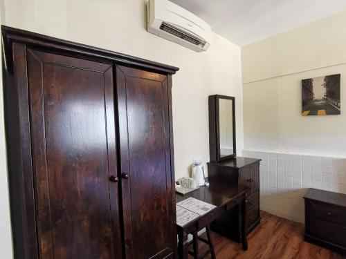 a bathroom with a large wooden cabinet and a desk at 8 Boutique By The Sea in George Town