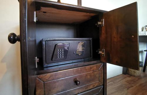 a wooden cabinet with a microwave inside of it at 8 Boutique By The Sea in George Town