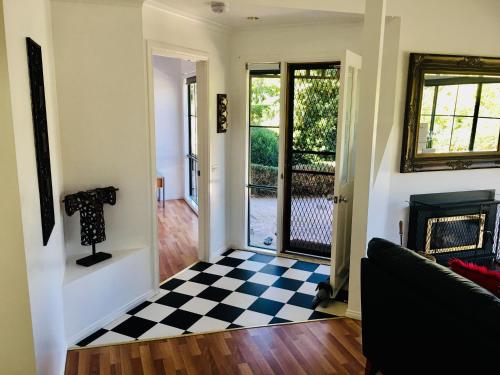 a living room with a checkered floor at Home Farm Healesville in Healesville