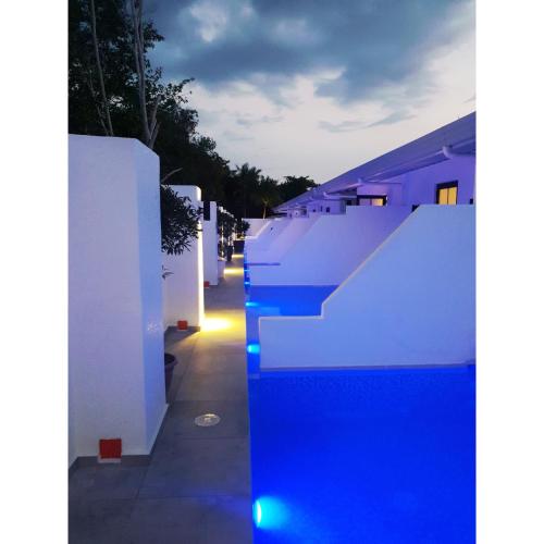 a row of white fences with blue lights on them at Marina Point Bay Resort in Panglao Island