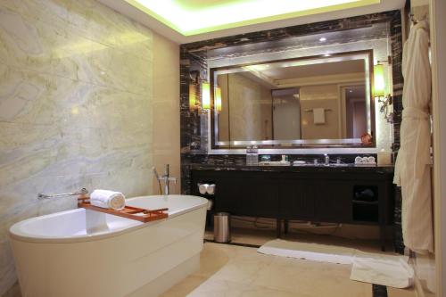 a bathroom with a tub and a large mirror at The Westin Qingdao - Instagrammable in Qingdao
