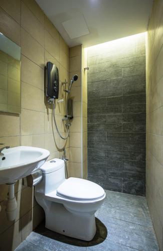 a bathroom with a toilet and a sink at Sovotel@Uptown 28 in Petaling Jaya