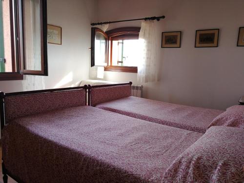 two beds sitting in a bedroom with a window at Agriturismo Santa Barbara in Mira