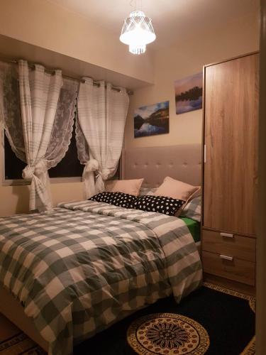 a bedroom with two beds and a chandelier at Patrick s Place in Davao City