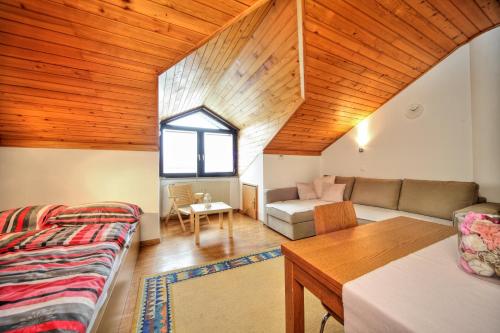 a living room with a couch and a table at Apartment Viki in Kranjska Gora