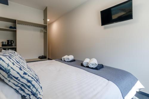 a bedroom with a bed with two towels on it at AQUA HOUSE in Sopot